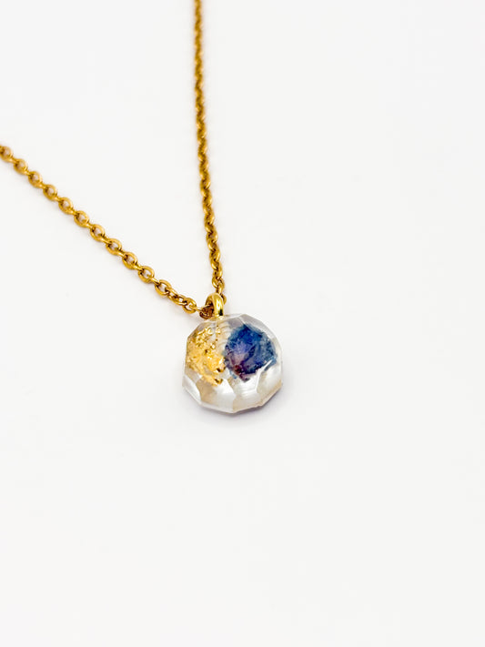 Necklace with a multicolored gemstone pendant on a white background