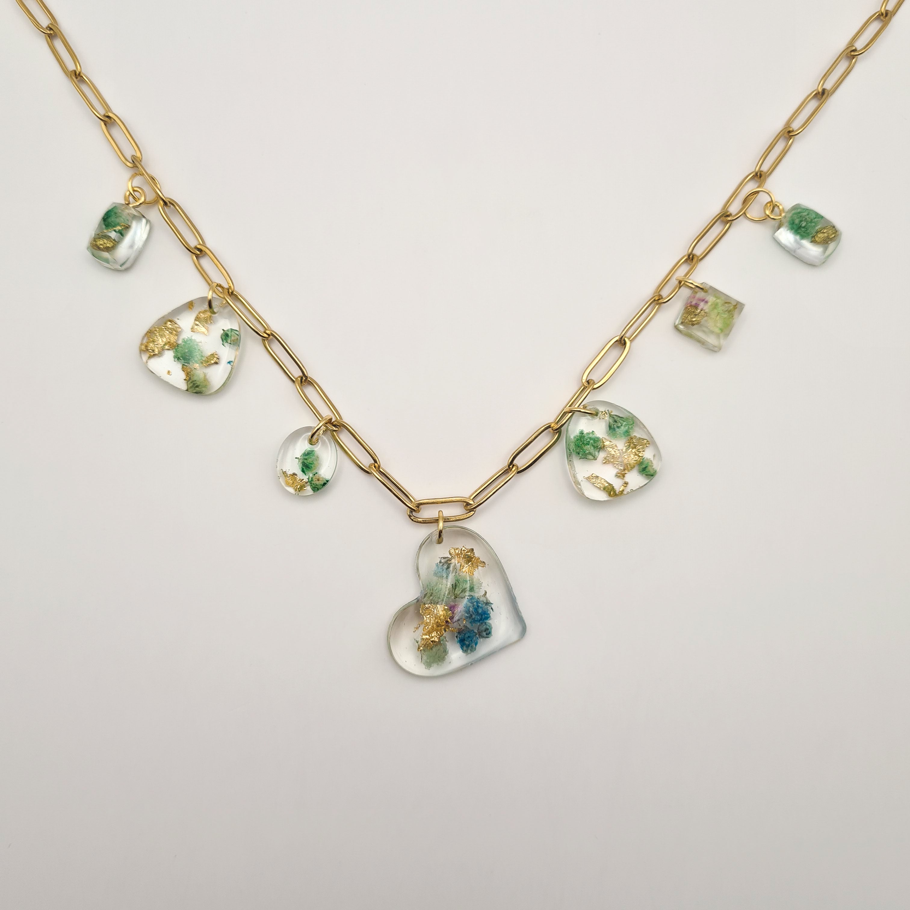 chunky Necklace with heart-shaped pendant and other pendants filled with real green and blue flowers