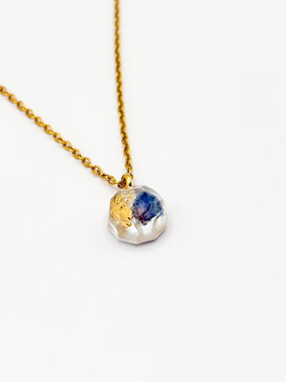 Necklace with a multicolored gemstone pendant on a white background