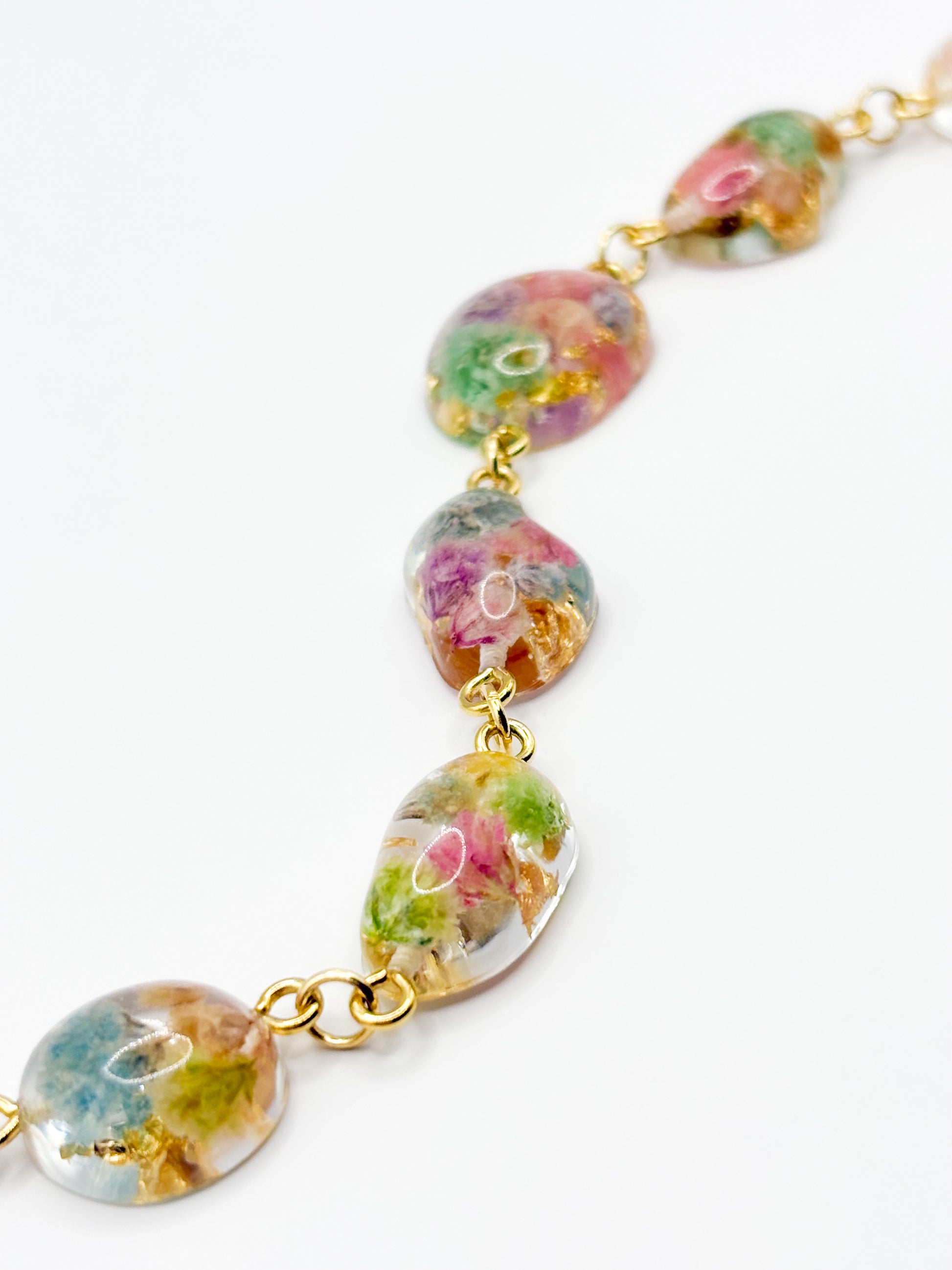 Bracelet with floral-patterned beads on a white background
