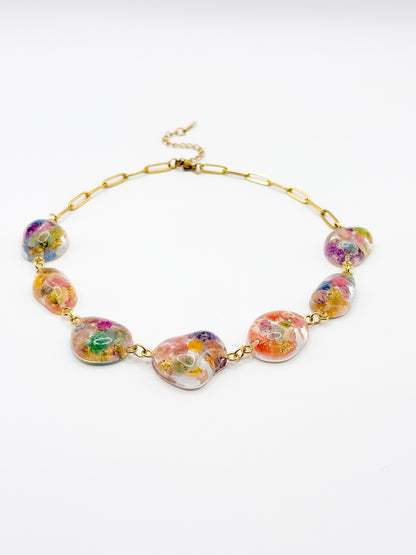 Colorful necklace with floral beads on a white background