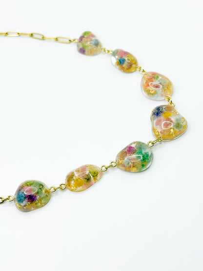 Necklace with floral-themed beads on a white background