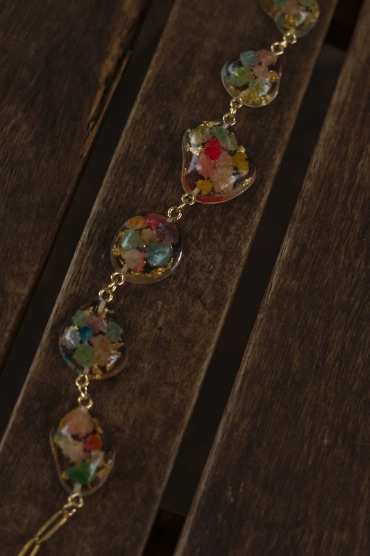 Necklace with colorful floral beads on a wooden surface